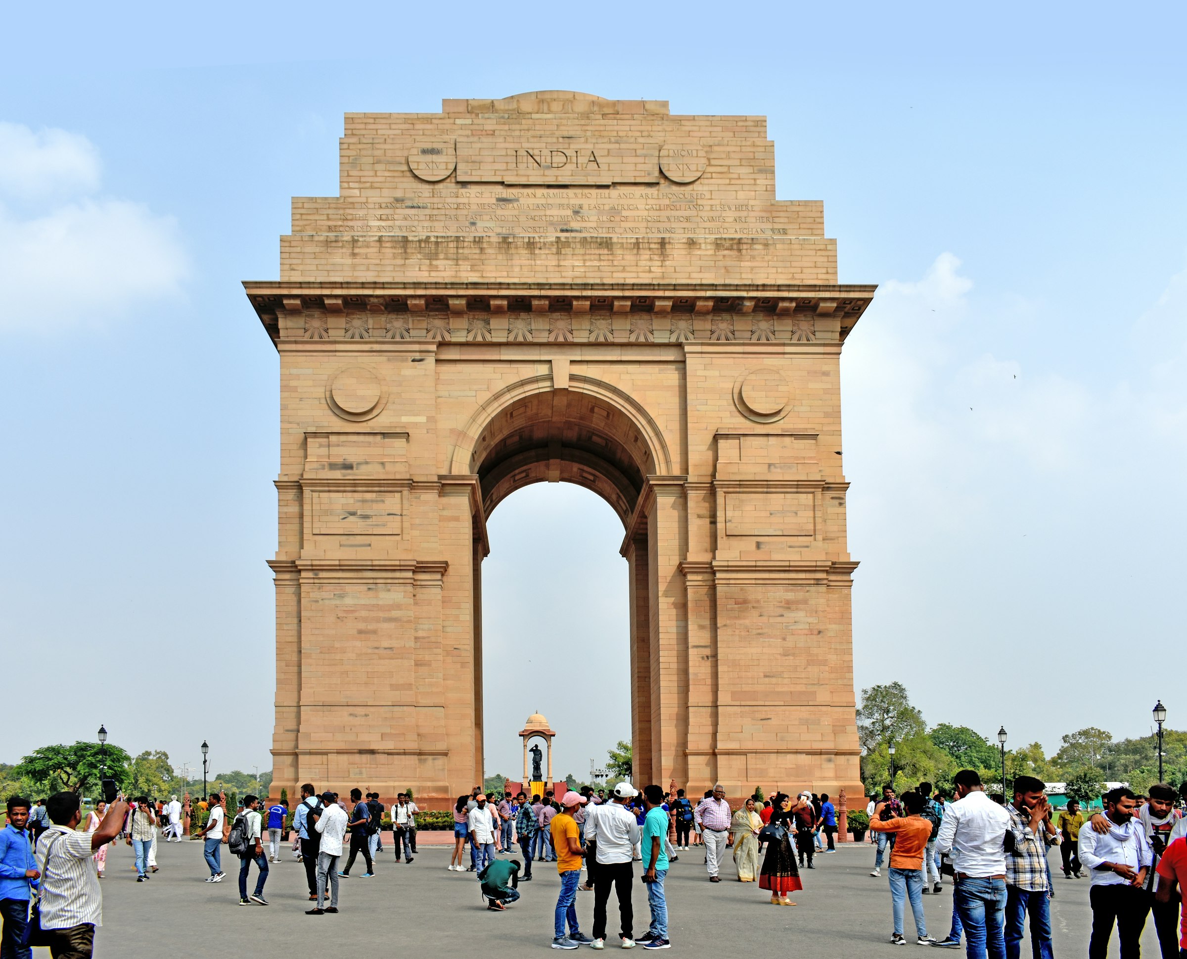 Visitors walking around the base of India Gate