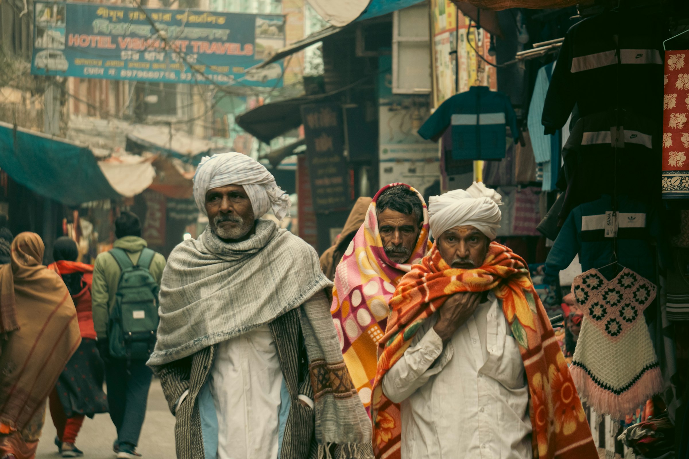 People walking through a crowded market street in Rishikesh