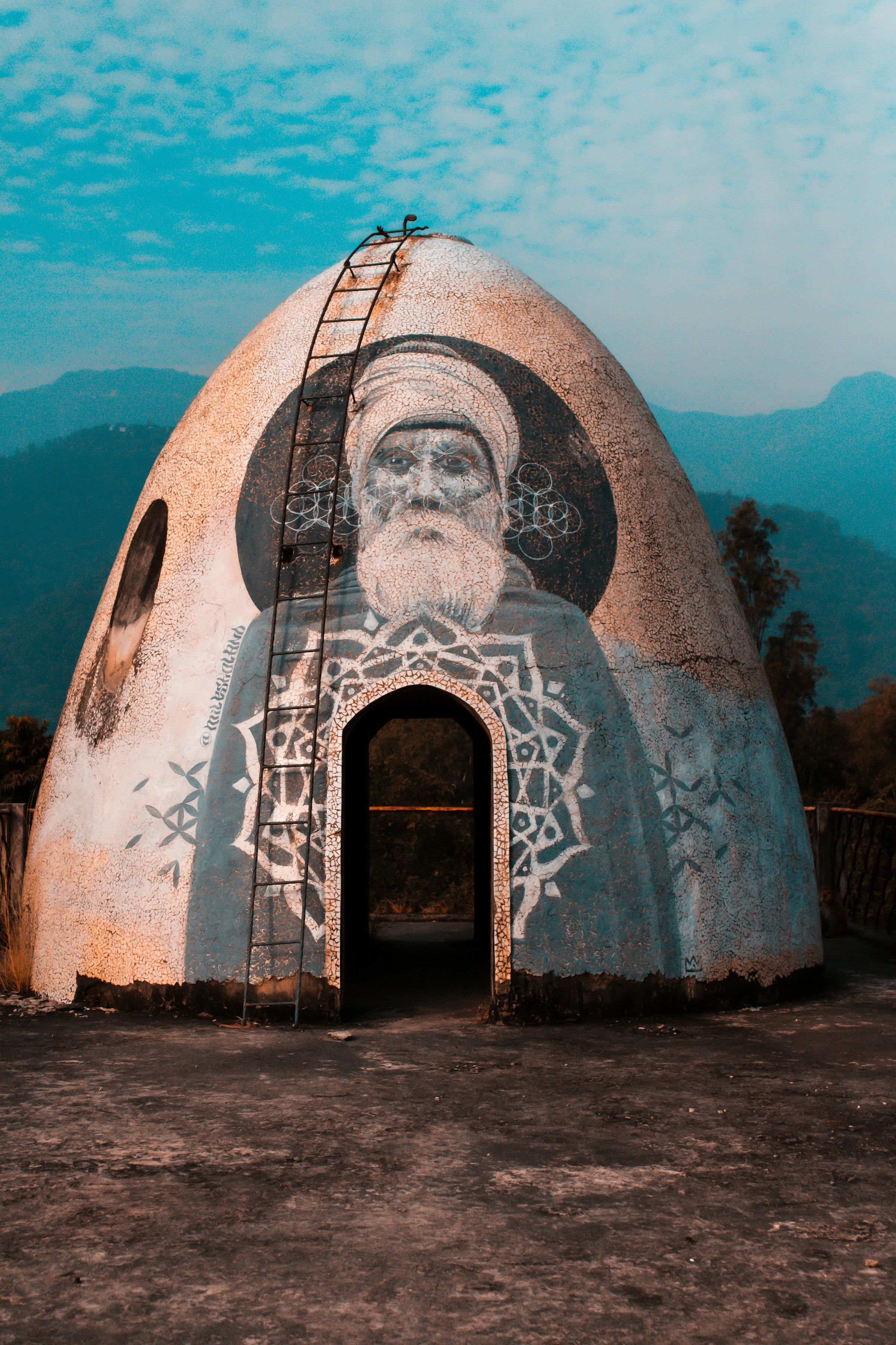 A weathered ashram building covered in graffiti