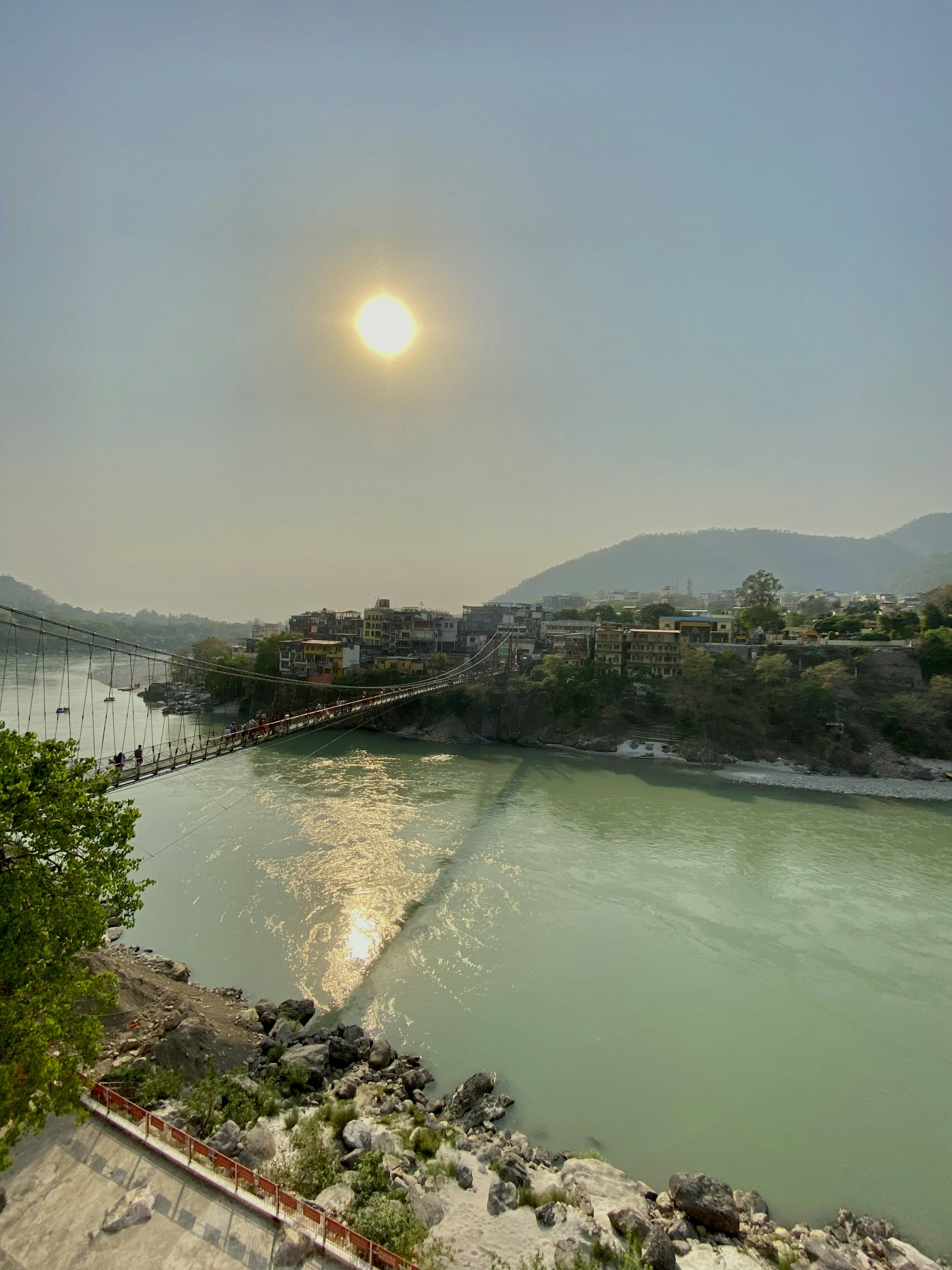 The river at sunset with a bridge in the distance