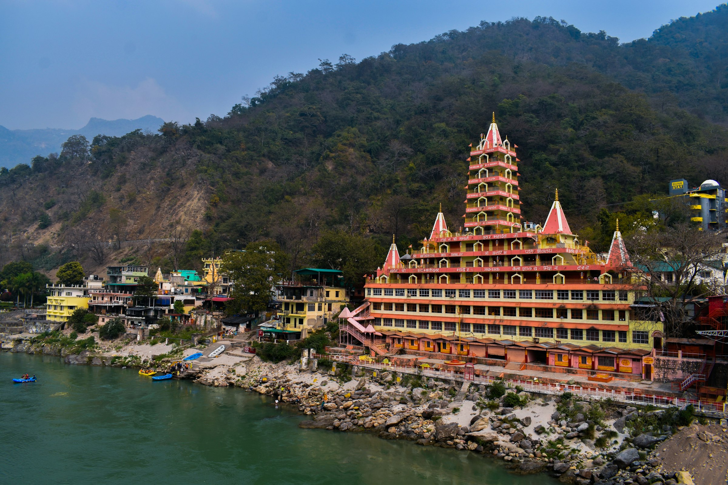 A tall tiered temple beside the river