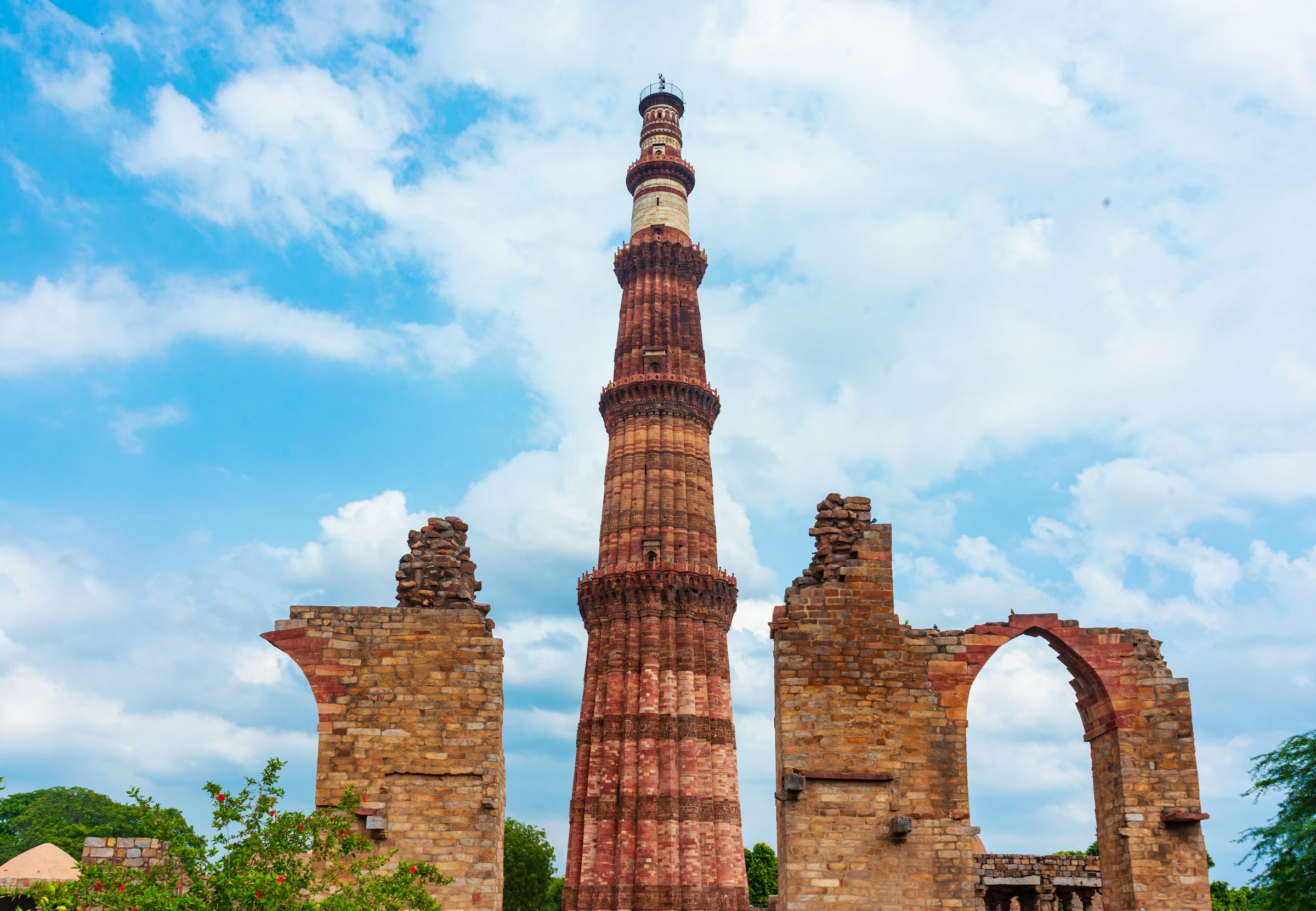 The Qutub Minar tower against a blue sky