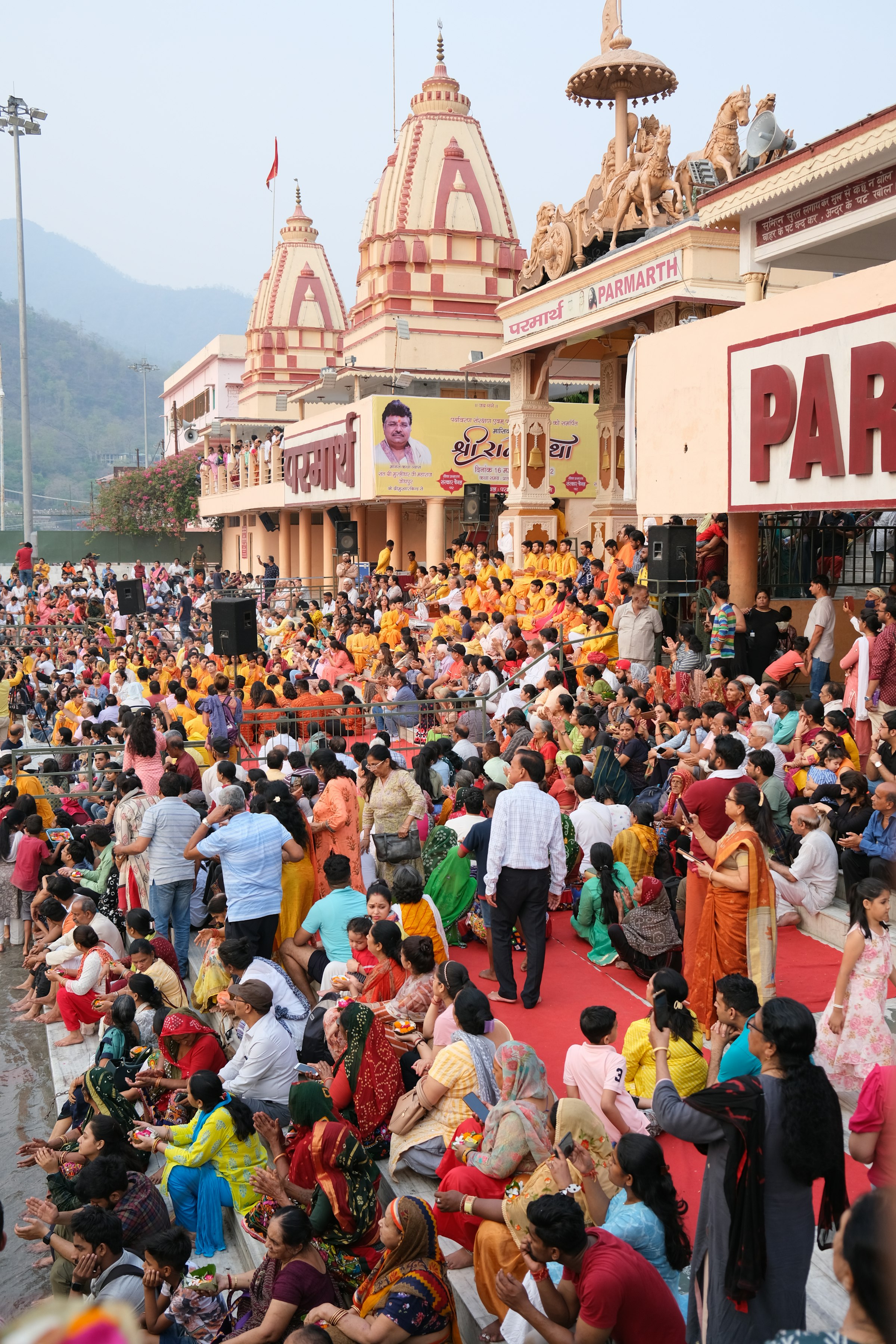 A crowd seated on the ghat during the Ganga aarti